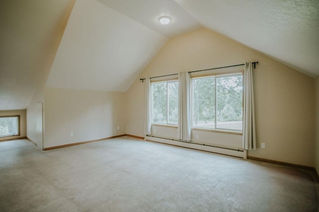 additional living space featuring carpet flooring, a baseboard heating unit, baseboards, and vaulted ceiling