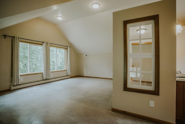 additional living space with lofted ceiling, carpet, baseboards, and a baseboard radiator