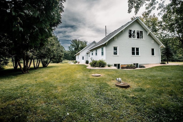 rear view of property with a yard