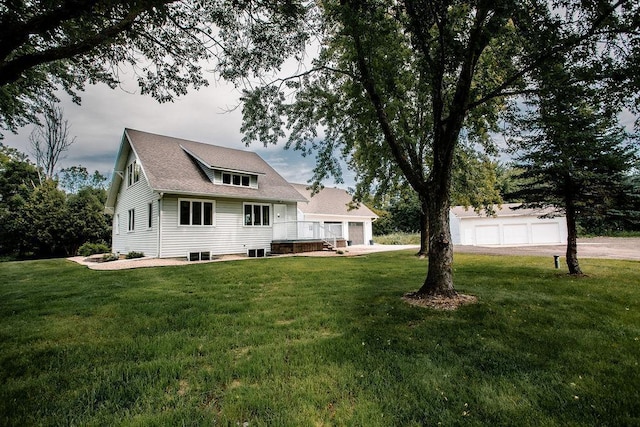 rear view of house with a lawn and a wooden deck