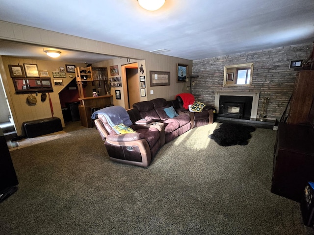 living room with a fireplace and carpet flooring