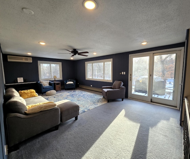 carpeted living room with a wall unit AC, plenty of natural light, a baseboard heating unit, and a textured ceiling