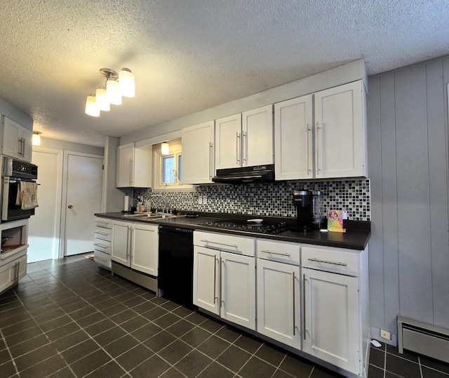 kitchen with a baseboard radiator, under cabinet range hood, a sink, black appliances, and dark countertops