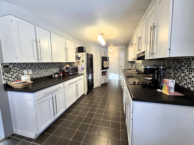 kitchen featuring dark tile patterned flooring, white cabinets, black appliances, tasteful backsplash, and dark countertops