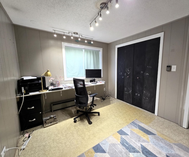 office space featuring a baseboard radiator and a textured ceiling