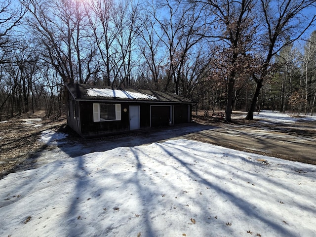 view of outbuilding with a garage and an outdoor structure