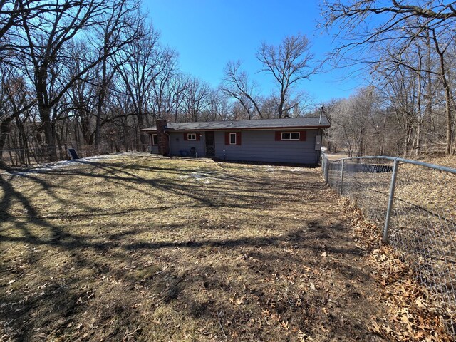 back of property with fence and a chimney
