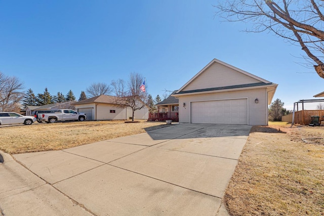 view of side of home featuring driveway and an attached garage