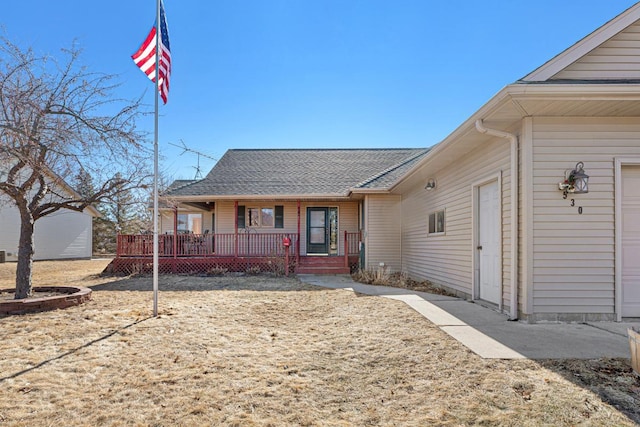 ranch-style home featuring a porch and a shingled roof