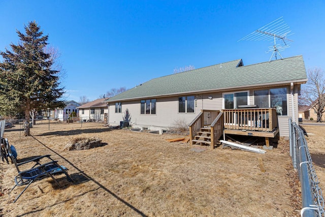 back of property featuring cooling unit, roof with shingles, fence, and a wooden deck