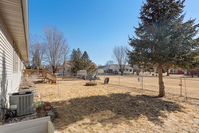 view of yard with a fenced backyard and central AC unit