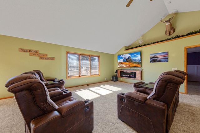 living room featuring carpet, a ceiling fan, a glass covered fireplace, high vaulted ceiling, and baseboards