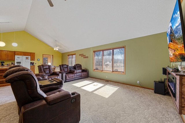 living room with light carpet, ceiling fan, baseboards, and lofted ceiling