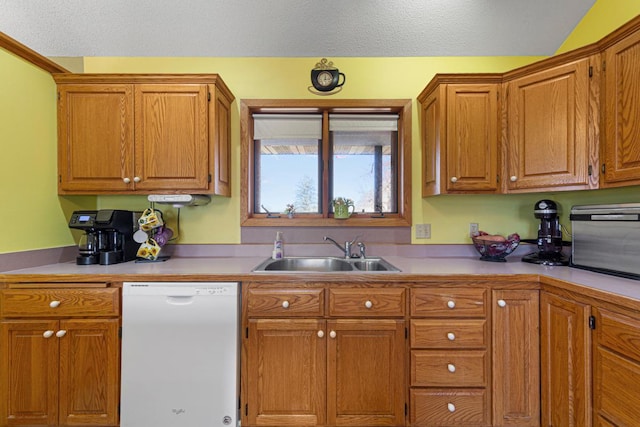 kitchen featuring a sink, brown cabinets, dishwasher, and light countertops