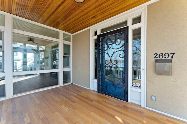 entrance to property with stucco siding