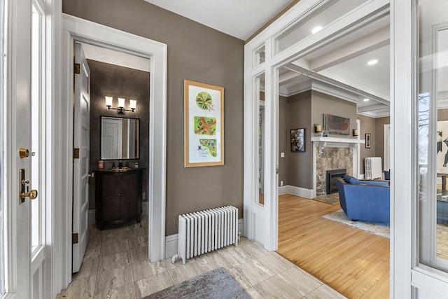 hall with recessed lighting, radiator, and baseboards