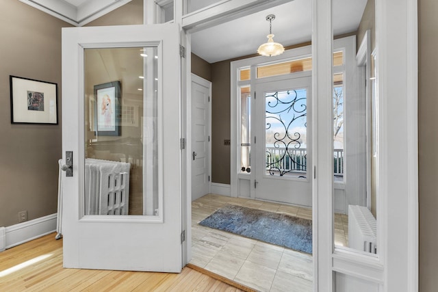 foyer with wood finished floors and baseboards