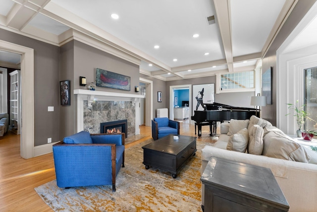 living area with visible vents, beamed ceiling, light wood-style flooring, coffered ceiling, and recessed lighting