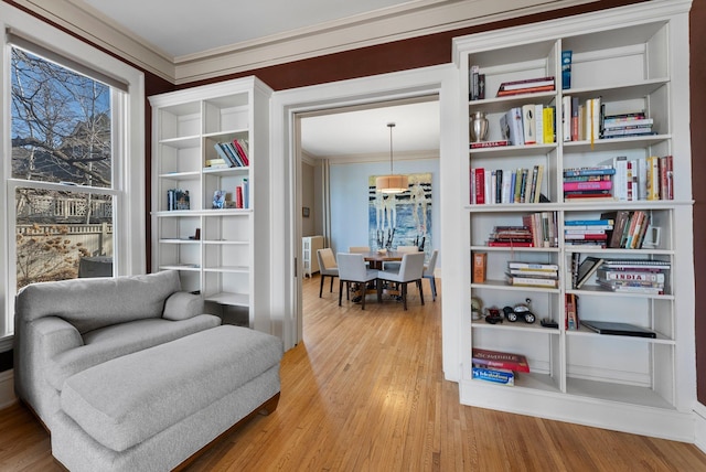 living area with light wood-style flooring, radiator, and ornamental molding