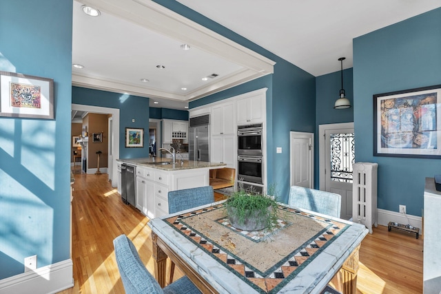 dining space with recessed lighting, light wood-type flooring, baseboards, and radiator heating unit