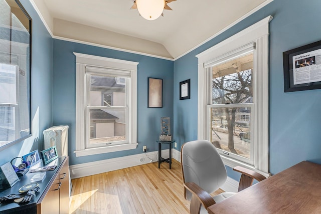 office with vaulted ceiling, crown molding, light wood-style floors, and baseboards