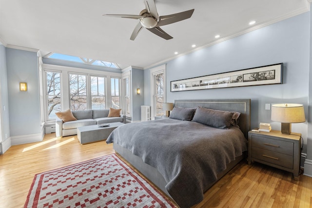 bedroom featuring recessed lighting, baseboards, wood finished floors, and crown molding