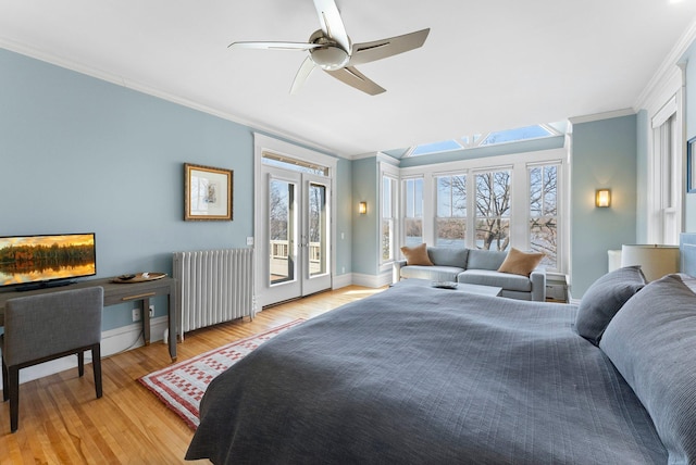 bedroom featuring light wood-type flooring, access to outside, radiator heating unit, crown molding, and baseboards