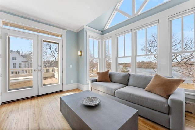 sunroom / solarium featuring lofted ceiling and french doors