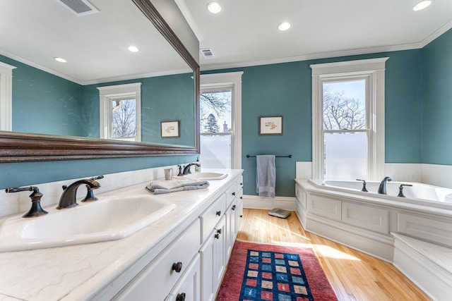 full bathroom featuring a wealth of natural light, visible vents, and a sink