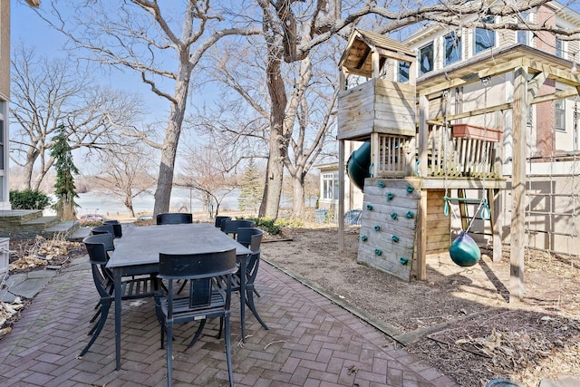 view of patio / terrace featuring playground community and outdoor dining area