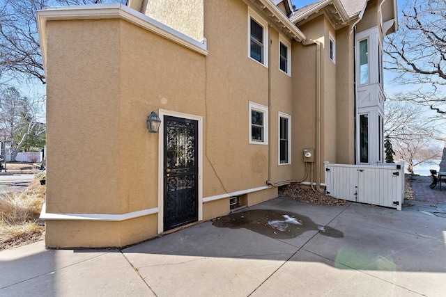 exterior space featuring stucco siding and a patio area