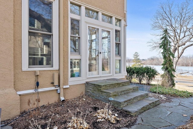 doorway to property with stucco siding