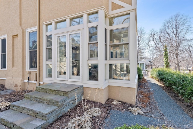 view of exterior entry with stucco siding