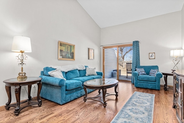 living room featuring high vaulted ceiling and wood finished floors