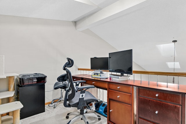 office area featuring vaulted ceiling with skylight and carpet flooring