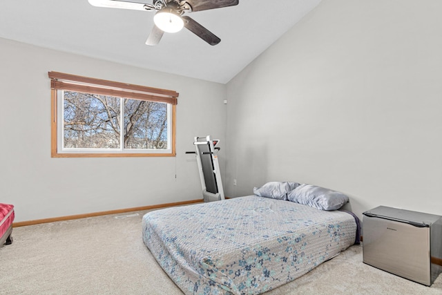 carpeted bedroom with lofted ceiling, a ceiling fan, and baseboards