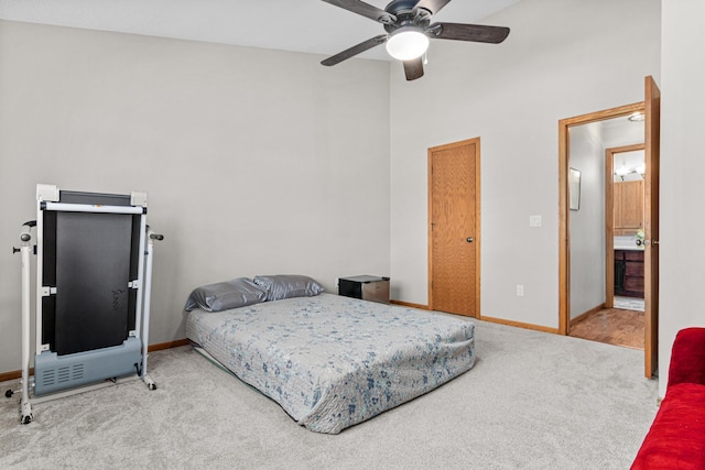 bedroom featuring carpet flooring, a high ceiling, and baseboards