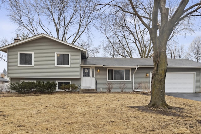 tri-level home with a garage and driveway