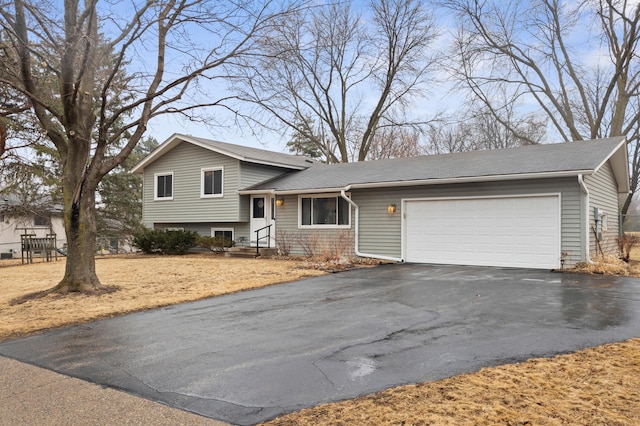 tri-level home with driveway and a garage