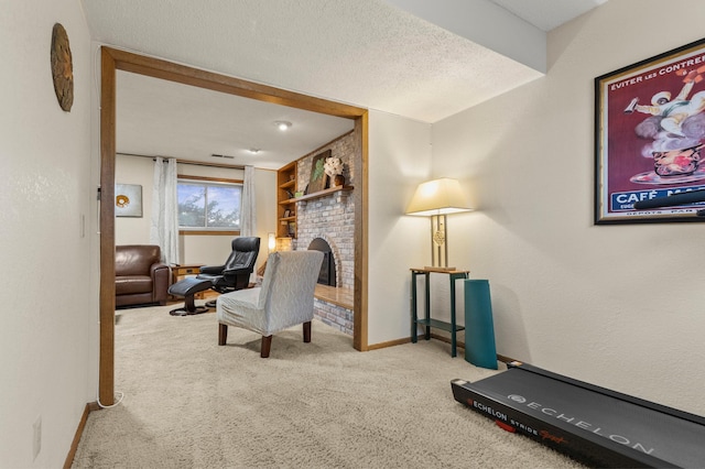 interior space featuring a textured ceiling, a fireplace, carpet flooring, and baseboards