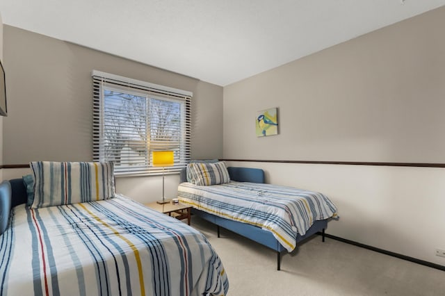 carpeted bedroom featuring baseboards