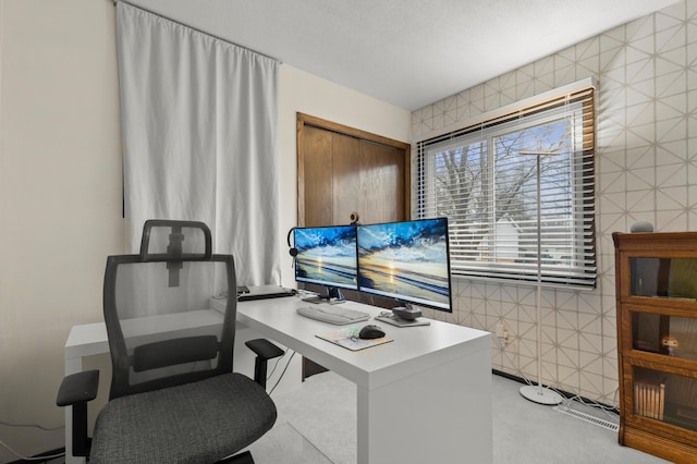 home office featuring tile walls and a textured ceiling