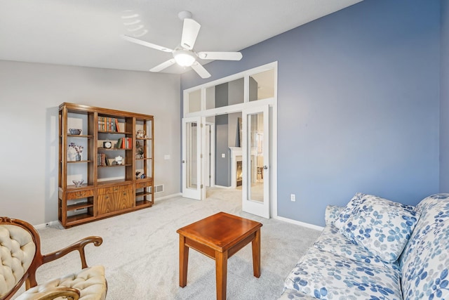 living room featuring baseboards, light colored carpet, ceiling fan, vaulted ceiling, and french doors