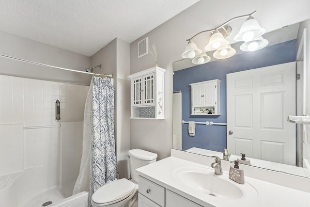 bathroom with a stall shower, visible vents, a textured ceiling, and toilet