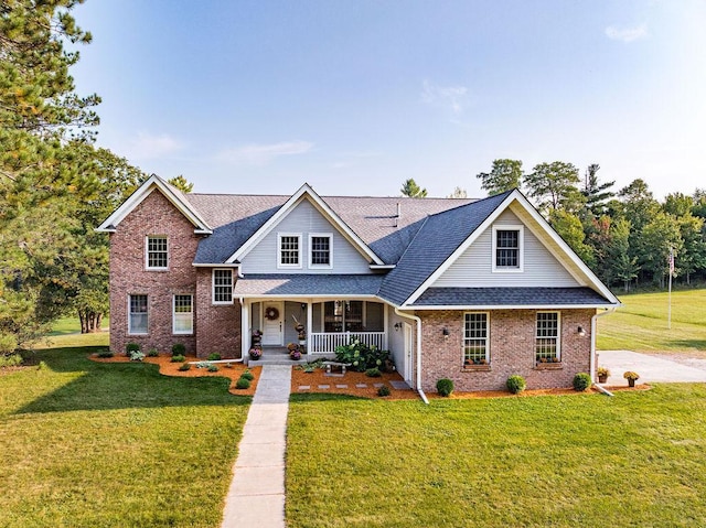 traditional-style home featuring a porch, brick siding, a front lawn, and roof with shingles