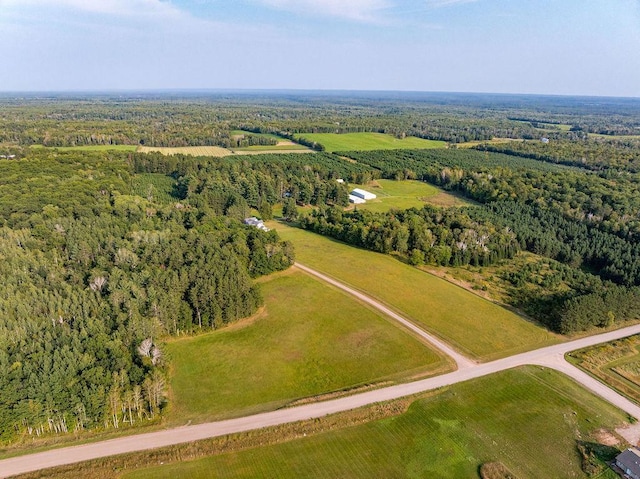 birds eye view of property with a forest view