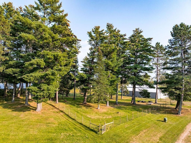 surrounding community with fence and a lawn