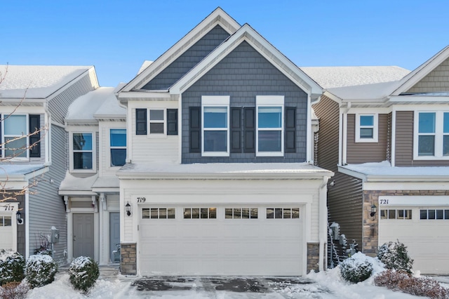 view of front of property with a garage and stone siding