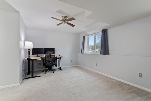 home office featuring light carpet, baseboards, and a ceiling fan