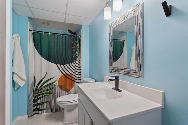 full bathroom with a shower with curtain, toilet, vanity, tile patterned flooring, and a drop ceiling